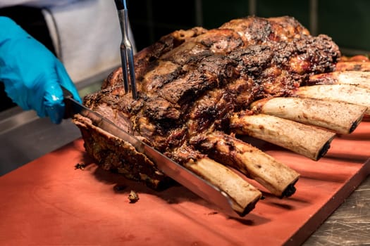 Chef Carving prime rib of  roast Wagyu beef