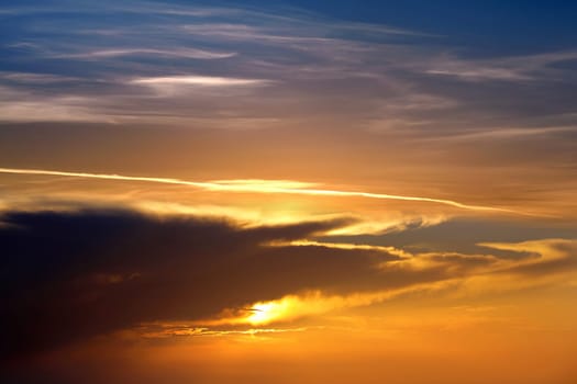 Beautiful cloudscape of colorful sunset sky with shining sun