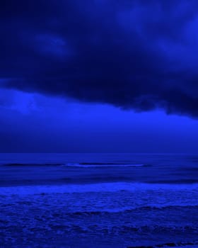 seascape image of waves on sea over stormy sky