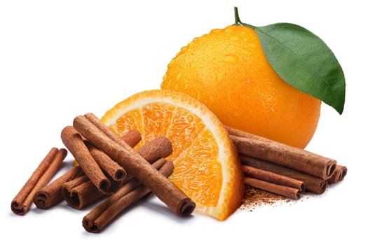 Whole and quarter of orange next to piles of cinnamon, in sticks and ground. Clipping paths, shadow separated