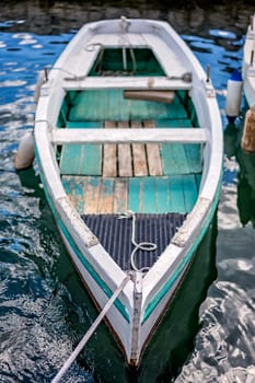 Small fishing boat on the shore in the beautiful Perast town in the Kotor Bay, Montenegro