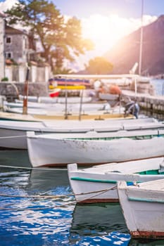 Anchored fishing boats on the shore in the beautiful Perast town in the Kotor Bay, Montenegro