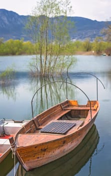 Neglected empty wooden fisherman boat on the shore of lake Skadar in Virpazar, Montenegro