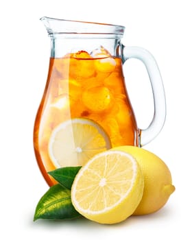 Iced tea in a pitcher. Jug full of iced tea or lemonade with lemons on foreground