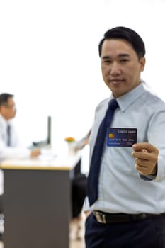 Portrait of Young adult Patient with credit card with examination room medical office background for insurance concept
