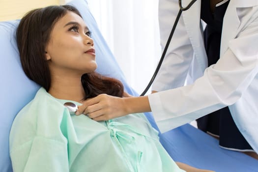 Asian Doctor make routine health check with patient in hospital ward