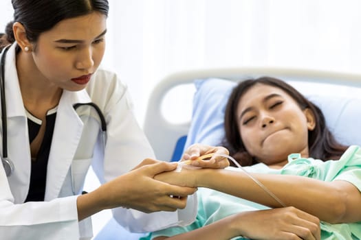 Female doctor preparing a saline tube for patient in the hospital.