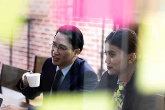 Business team have a meeting in a cafe with white board in foreground