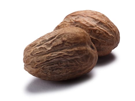 Two nutmegs (seeds of Myristica fragrans). Clipping paths, shadow separated
