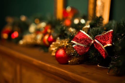 Close up of element of decoration with Christmas tree with red checkered bows and ribbons in living room. Beautiful handmade decoration for candles. Concept of Christmas and New Year holidays.