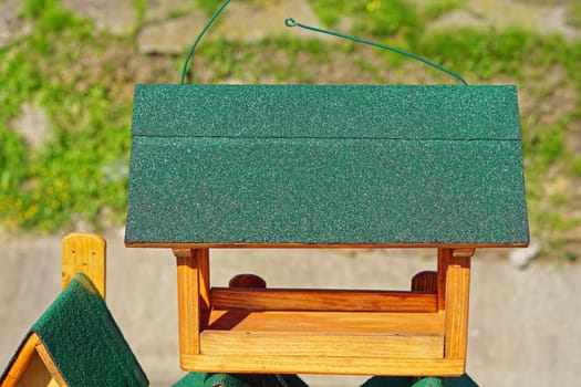 New wooden bird feed house with green roof