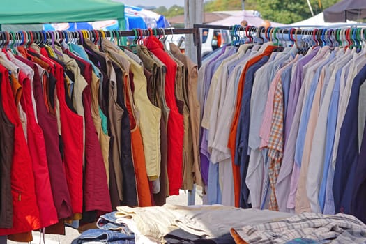 Shirts and vests hanging at clothes rails