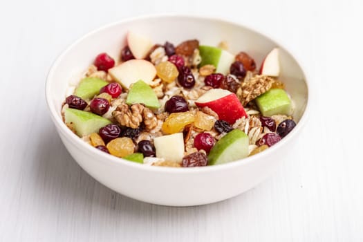 Oatmeal with dried cranberries, black and golden raisins, red and green apples, walnuts and maple syrup. Healthy eating