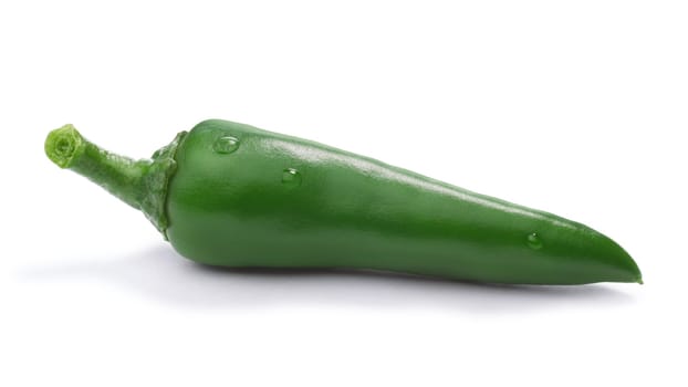 Single green chili pepper (Capsicum Annuum) with few droplets. Clipping paths, shadow separated, infinite depth of field