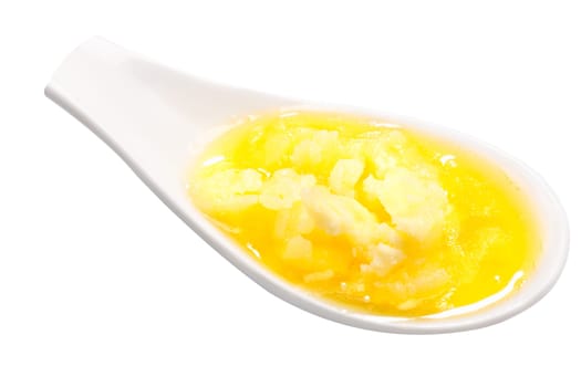 Melted ghee, a clarified butter (milk fat), spoonful