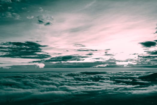 Vintage style red cyan two tone color of beautiful nature landscape cloud and fog like the sea is covered peak in winter morning during sunrise at Phu Ruea National Park, Loei province, Thailand