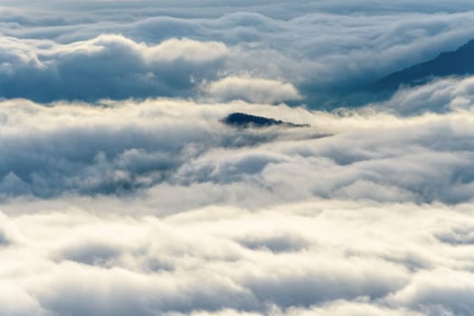 Beautiful nature landscape clouds and fogs like the sea is covered peaks in winter morning during sunrise at viewpoint of Phu Ruea National Park, Loei province, Thailand