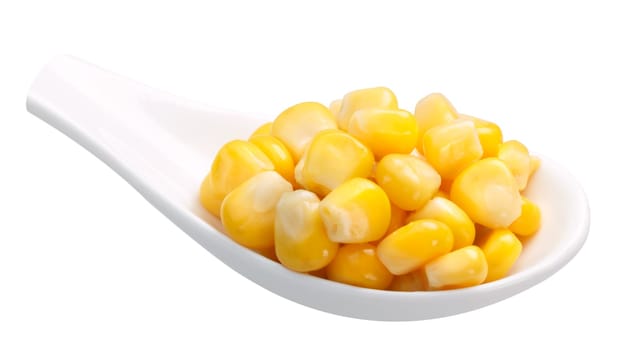 Spoon of canned corn grains (maize). Clipping path
