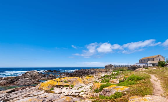 Landscape with sea,cliff, beach and blue sky. Galicia Spain. Vacation travel.