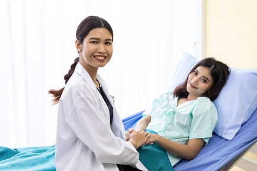 medical doctor holding patient's hands to cheer up patient