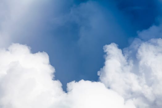 Big white puffy clouds and blue sky background. Dramatic hight detail weather pattern and textures