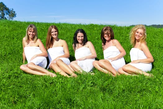 Woman group in towel on the summer meadow