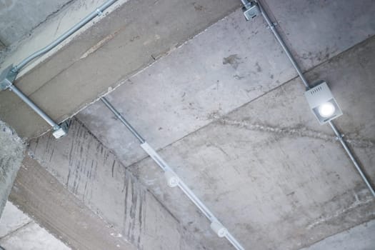 Ceiling metal pipe of electricity cable in building, stock photo