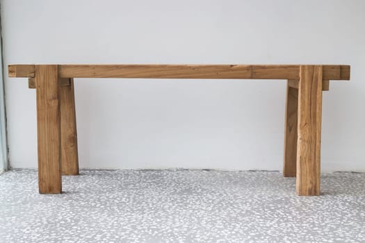 Single wooden bench in the room, stock photo