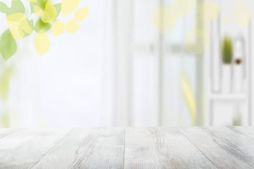 Table top and blur interior background. Rustic wooden bright table top and blurred kitchen interior background. Template for your product display montage.