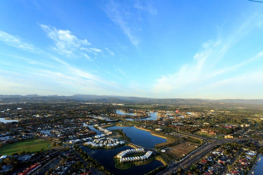 View of a hot air balloon flying at sunrise over the canals at the Gold Coast, Queensland Australia