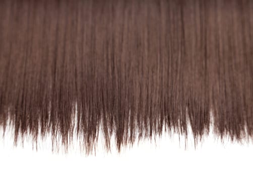 Closeup on luxurious straight glossy brown hair