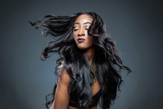Black beautiful woman with long luxurious shiny hair