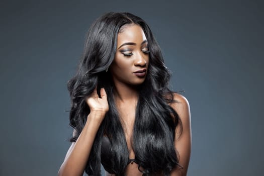 Black beautiful woman with long luxurious shiny hair