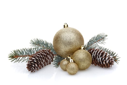 Still life with gold sparkling balls, cones and fir branches isolated on a white background with reflection. New Year and Christmas decorations