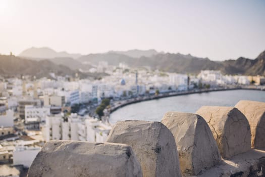 Muscat city at sunset. Selective focus on details of fort. Sultanate of Oman.