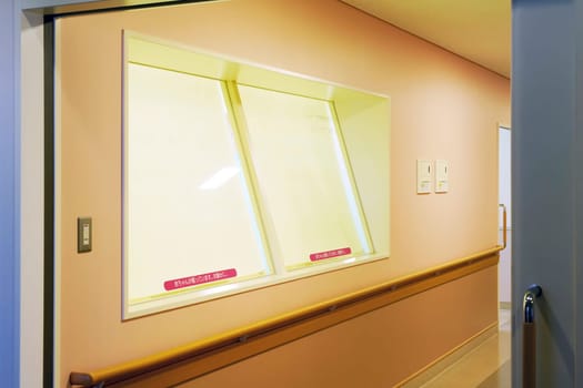 KAGAWA, JAPAN - NOVEMBER 08, 2018 Window for newborn care hospital nursery ward interior with babies in cribs. looking through window in Mitoyo hospital