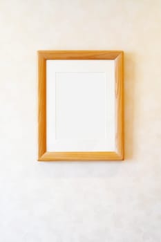 Blank wooden picture frame on the wall, rectangular photo frame with shadow