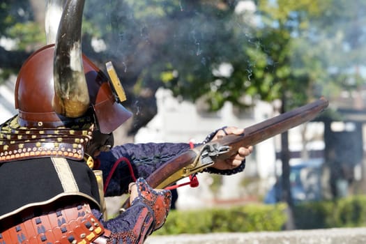 Japanese samurai clothing yoroi and kabuto uniform with old rifle