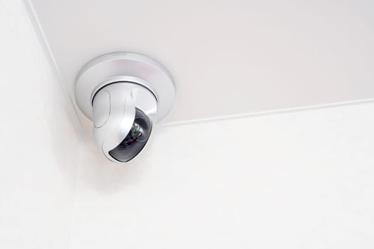 Security camera on white ceiling with crime system. house CCTV camera