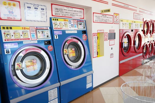 KAGAWA, JAPAN - NOVEMBER 14, 2018: Row of industrial washing machines in a public laundromat