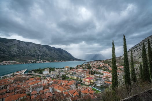 Homes and houses in Kotor town and stunning landscape of the Bay of Kotor, as seen from the trail to the Chapel of Our Lady of Salvation, Montenegro
