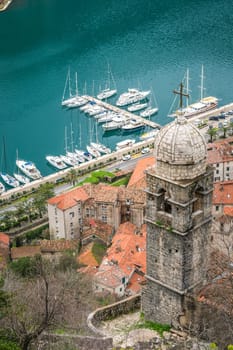 The dome and bell tower of The Chapel of Our Lady of Salvation with Kotor Bay harbour and marina below, Montenegro