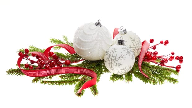 Still life with white sparkling balls, red ribbon and fir branches isolated on a white background. New Year and Christmas decorations