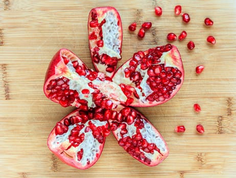 Open pomegranate fruit on a cutting board