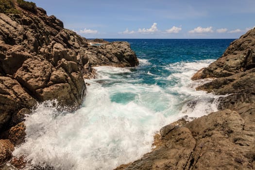 Tide in a small rocky cove on an island in BVI