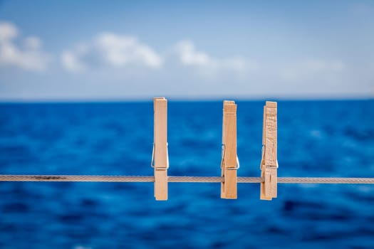 Cllose-up image of wooden cloth pins on a sailboat railing