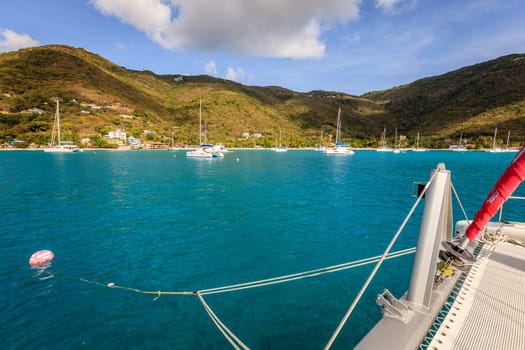 Sailing catamaran on a mooring ball in a harbor in British Virgin Islands