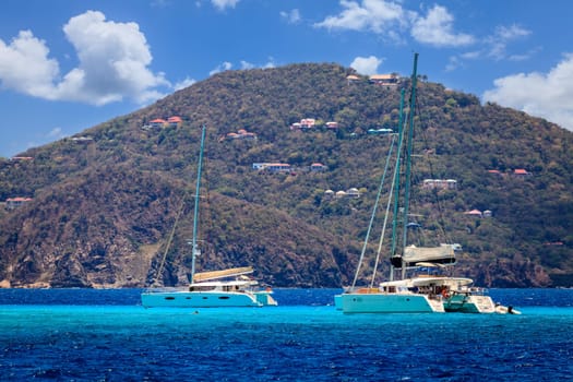 Luxury sailing catamarans near a resort island in BVI