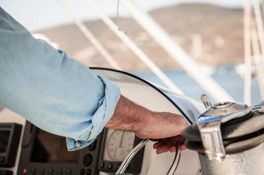 Close-up image of a man's hand on throttle control of a boat