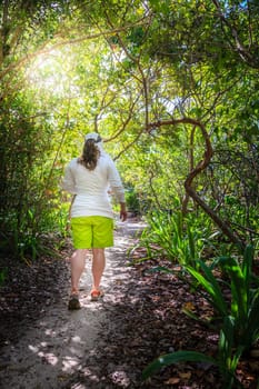 Woman is walking through a forest on a small island in the Caribbean